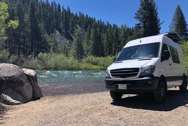 White van parked outdoors alongside lake | Quality Automotive Servicing